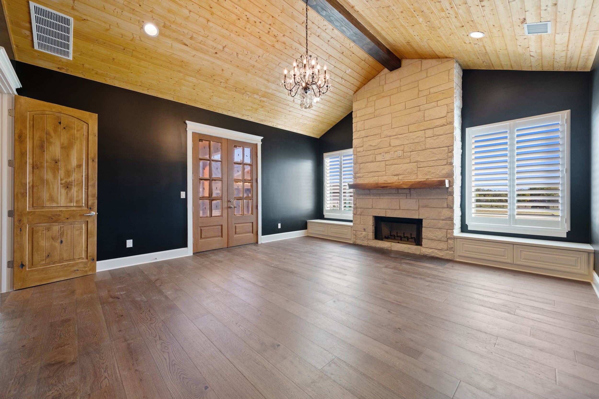 Entry hall with an iron and glass front door and lantern pendant