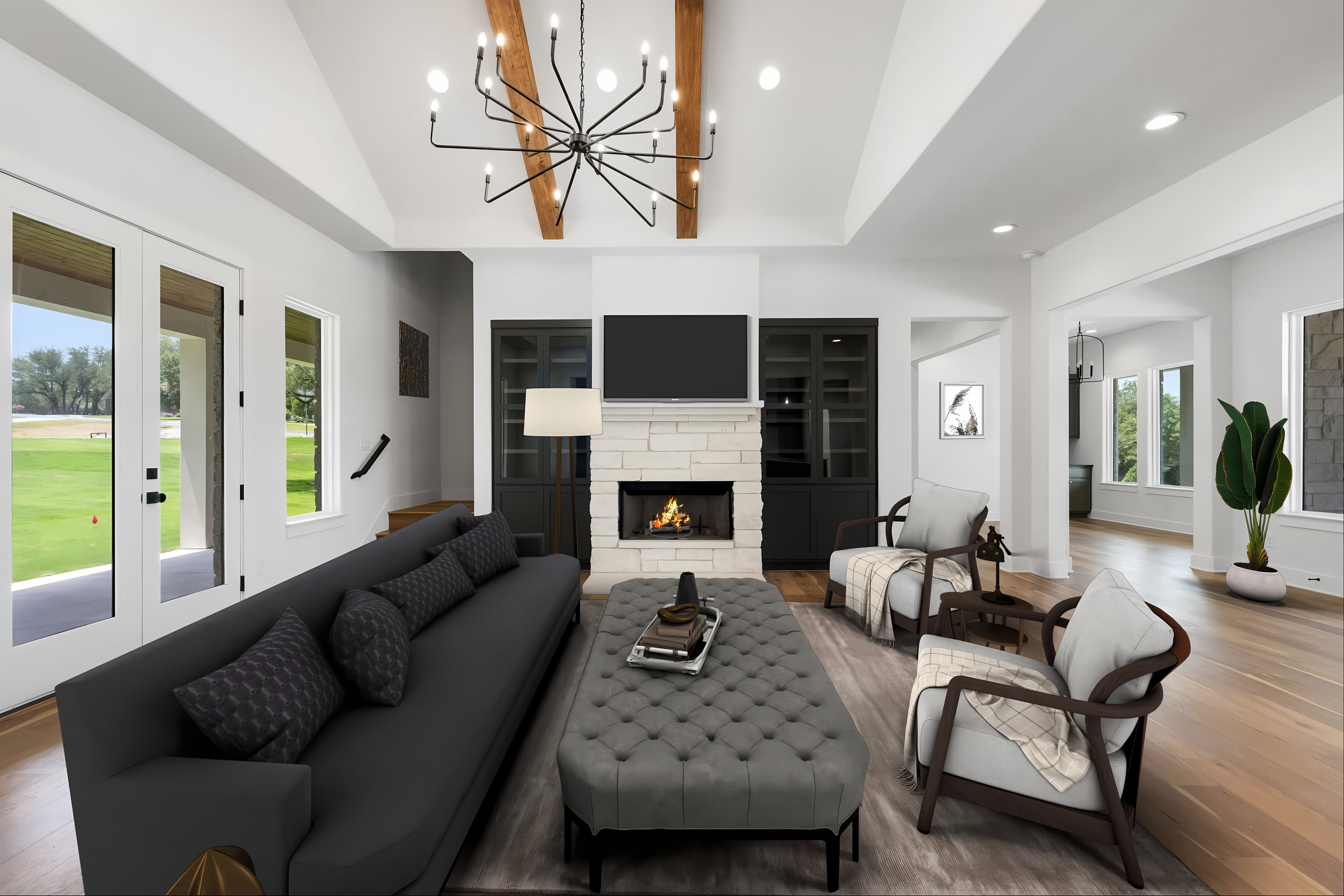 Living room of a Chance Leigh custom home: limestone fireplace, cedar beams and a vaulted ceiling
